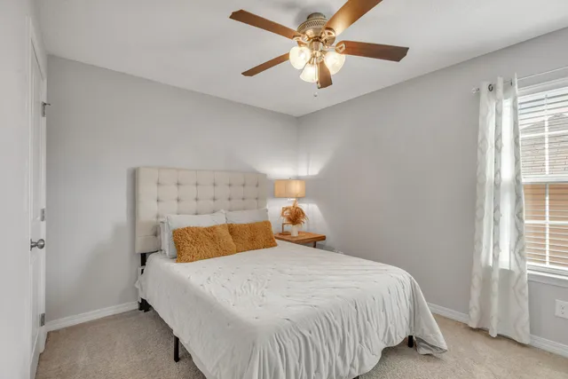 a bedroom with a bed and window