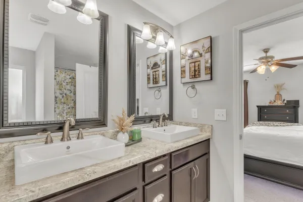 a bathroom with a double vanity sink and a mirror