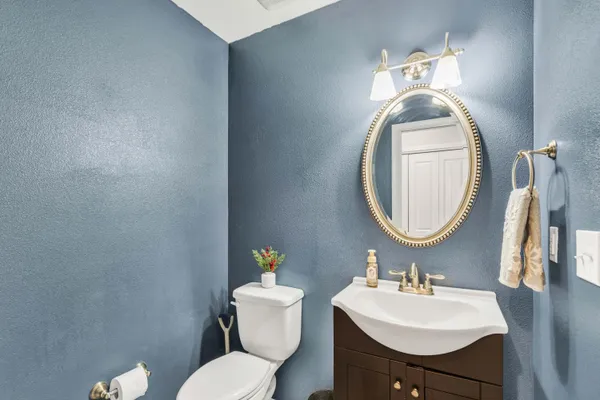 a kitchen with kitchen island granite countertop wooden floors and stainless steel appliances