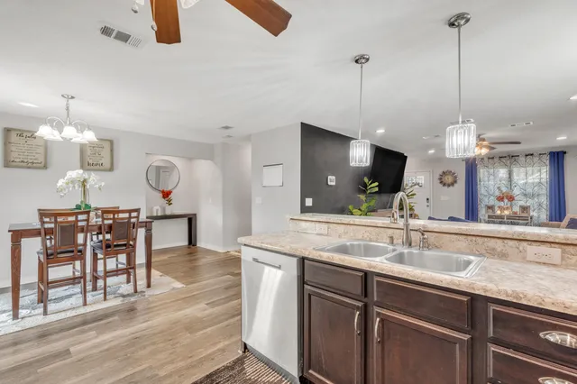 a view of a dining room with furniture and chandelier