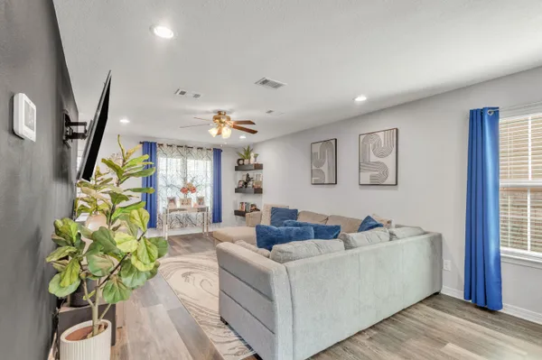 a living room with furniture and a potted plant