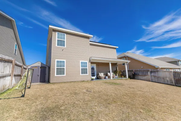 a view of a house with backyard and porch