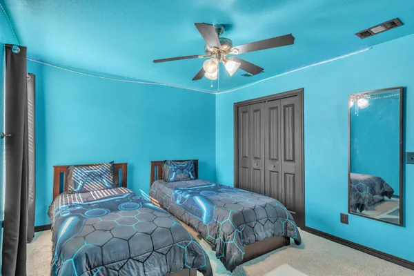 a bedroom with a large bed and a chandelier