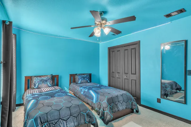 a bedroom with a large bed and a chandelier