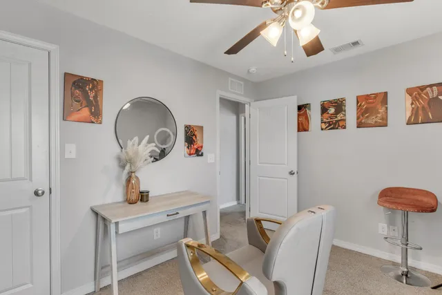 a view of a room with furniture and wooden floor