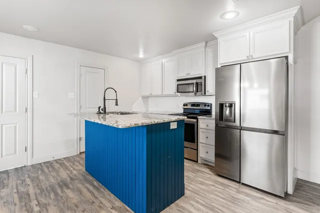 a kitchen with a refrigerator sink and microwave
