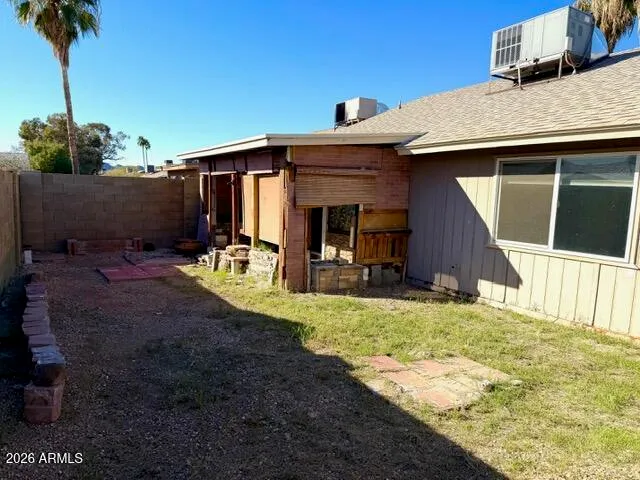 a view of a house with backyard porch and sitting area