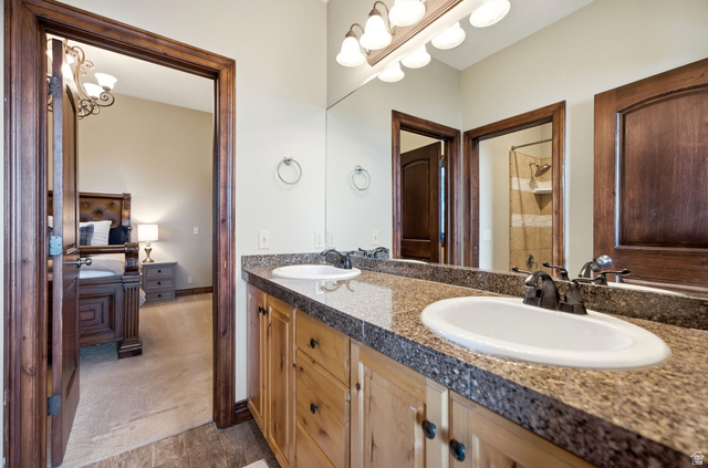 335 Bern Way Midway, UT 84049 - Photo 50 of 88 Bathroom featuring a double vanity with stone countertops and wood cabinetry