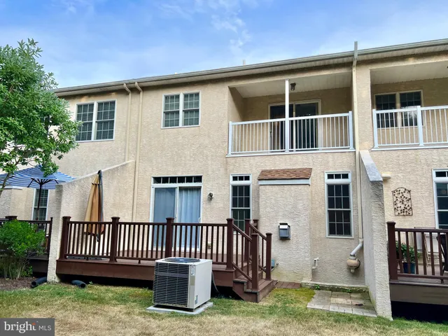 a view of a house with a deck and a yard