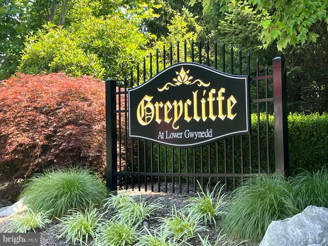 a sign that is sitting on a wooden fence