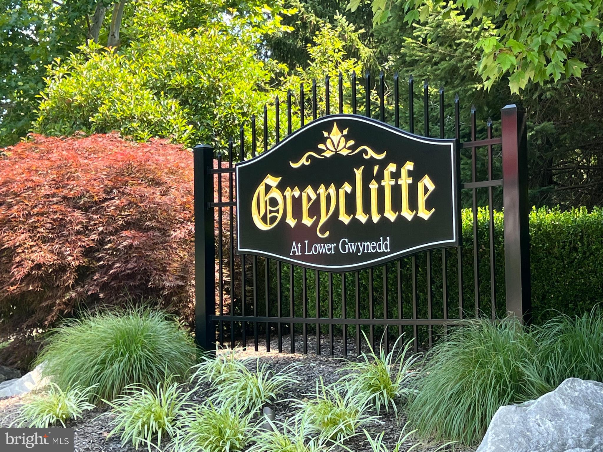 668 Greycliffe Lane Lower Gwynedd, PA 19002 - Photo 3 of 33 a sign that is sitting on a wooden fence