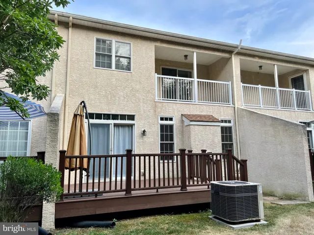 a view of a house with a small deck and a chair