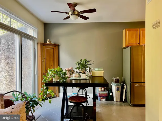 a view of a dining room with furniture and a potted plant