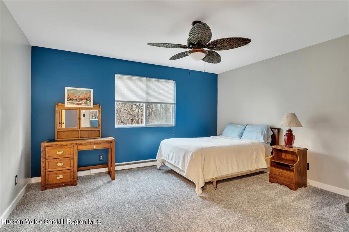 114 Ford Hill Road Hunter, NY 12442 - Photo 14 of 40 a bedroom with a bed and a chandelier