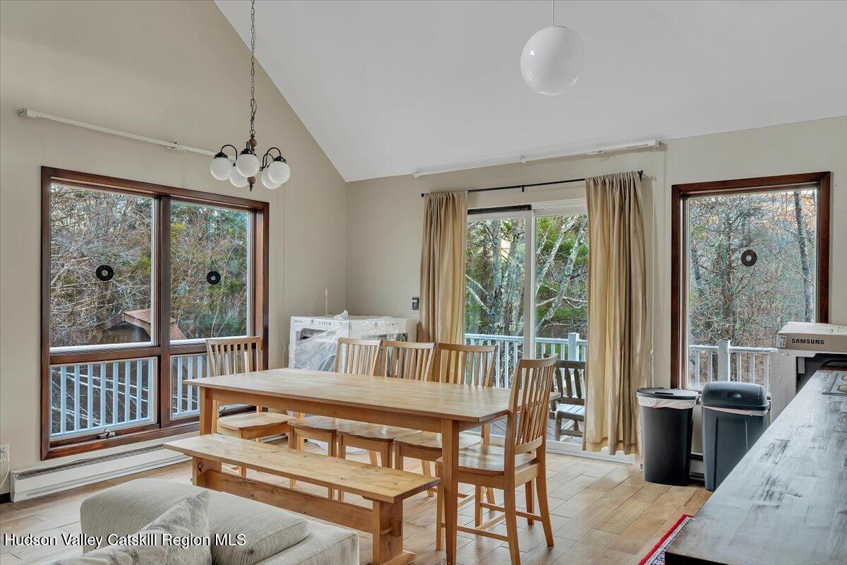 114 Ford Hill Road Hunter, NY 12442 - Photo 21 of 40 a living room with furniture a large window and a chandelier