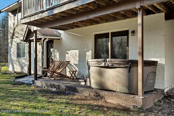 a backyard of a house with table and chairs