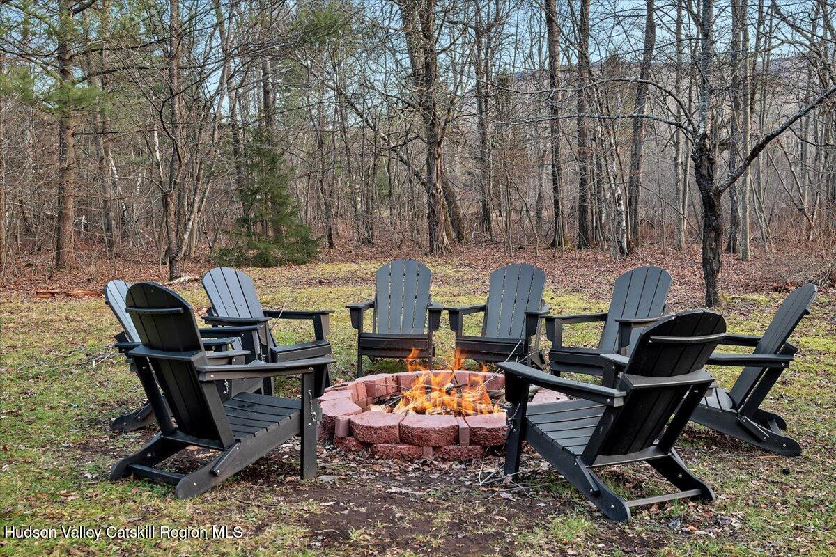 114 Ford Hill Road Hunter, NY 12442 - Photo 39 of 40 a backyard of a house with table and chairs