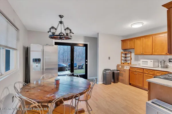 a kitchen with a dining table and chairs