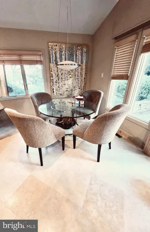 a kitchen with a table chairs and a wooden floor