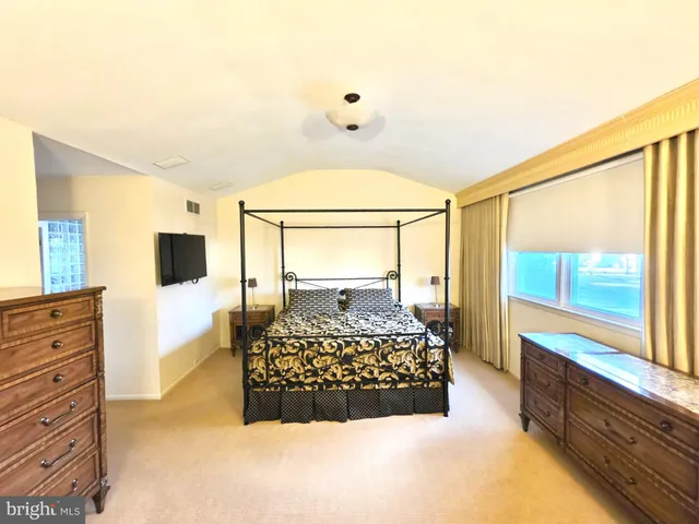 a bedroom with a bed and window
