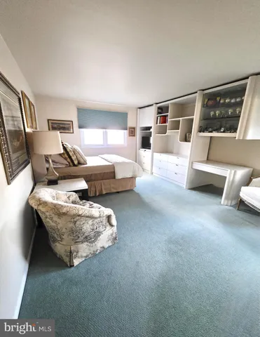 a view of a workspace with wooden floor and a window