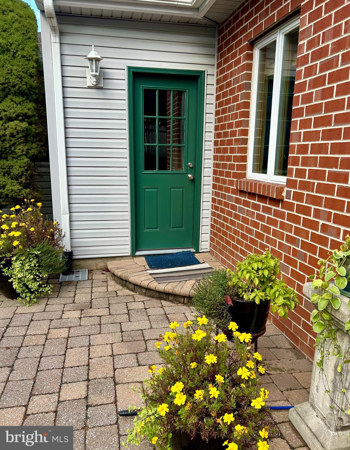 992 Sheffield Lane Huntingdon Valley, PA 19006 - Photo 30 of 31 a view of a brick house with a flower garden