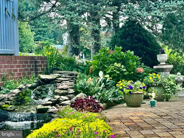 a backyard of a house with a yard and outdoor seating