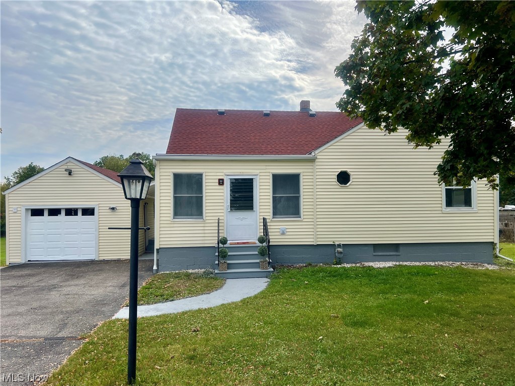 3923 Jaeger Road Lorain, OH 44053 - Photo 1 of 34 View of front of home with a front lawn and a garage