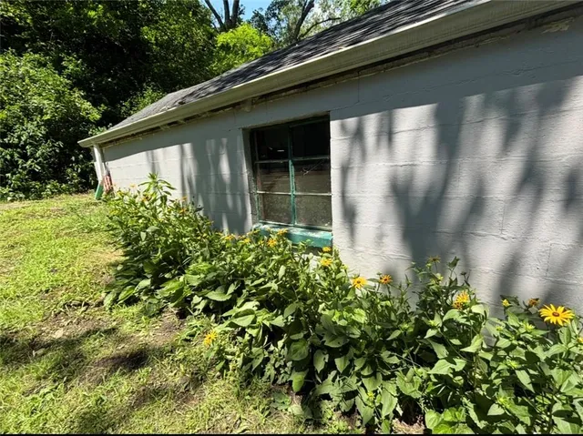a flower garden in front of a house
