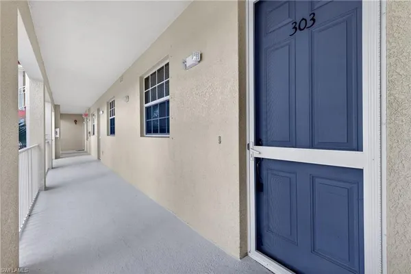 a view of a hallway with wooden floor and closet