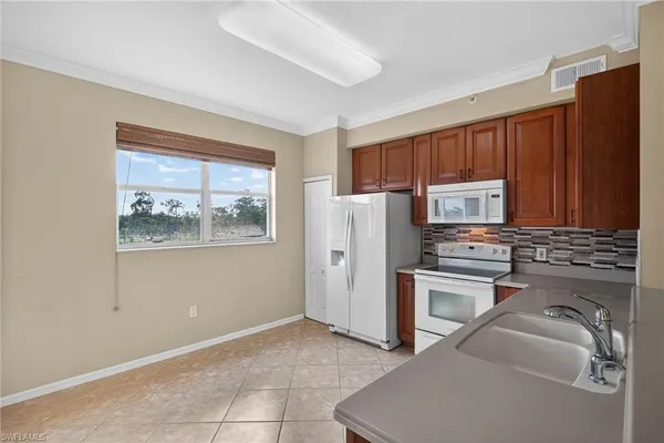 a kitchen with stainless steel appliances granite countertop a refrigerator sink and stove