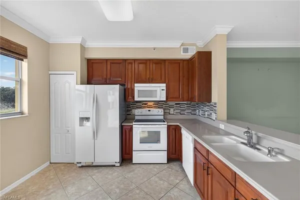 a kitchen with a sink stove and refrigerator