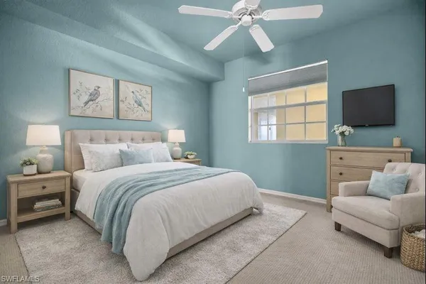 a bedroom with a large bed and a flat screen tv