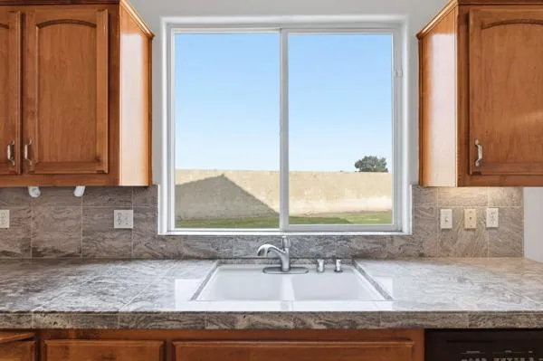 a kitchen with sink and window