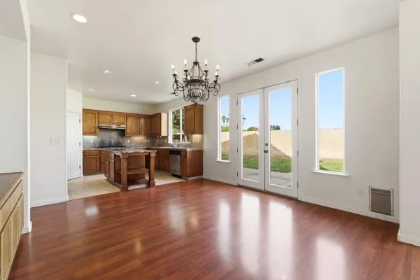 a view of a kitchen with furniture and wooden floor