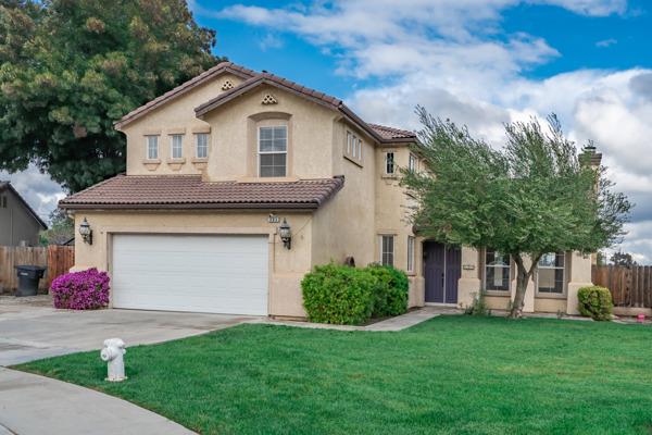 384 Millbrook Street Hanford, CA 93230 - Photo 2 of 59 a front view of a house with garden