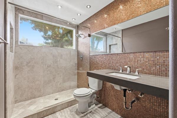 384 Millbrook Street Hanford, CA 93230 - Photo 24 of 59 a bathroom with a toilet sink and mirror