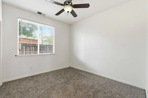 a view of a room with wooden floor and window