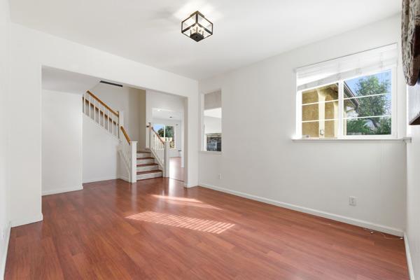384 Millbrook Street Hanford, CA 93230 - Photo 29 of 59 a view of an empty room with wooden floor and a window