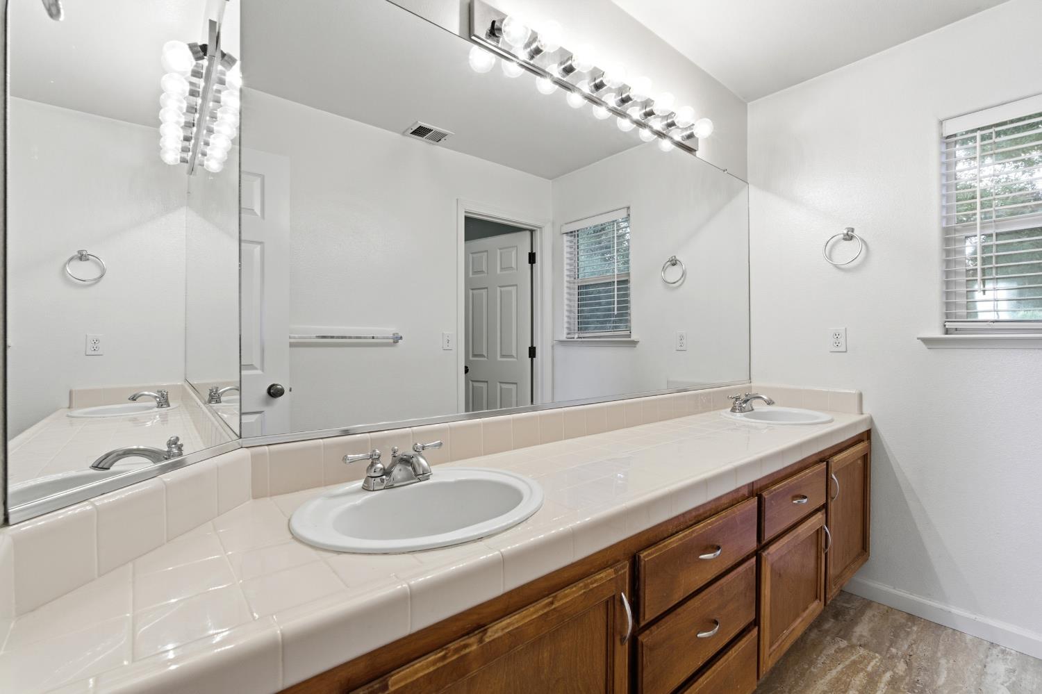 384 Millbrook Street Hanford, CA 93230 - Photo 36 of 59 a bathroom with a sink double vanity and a mirror