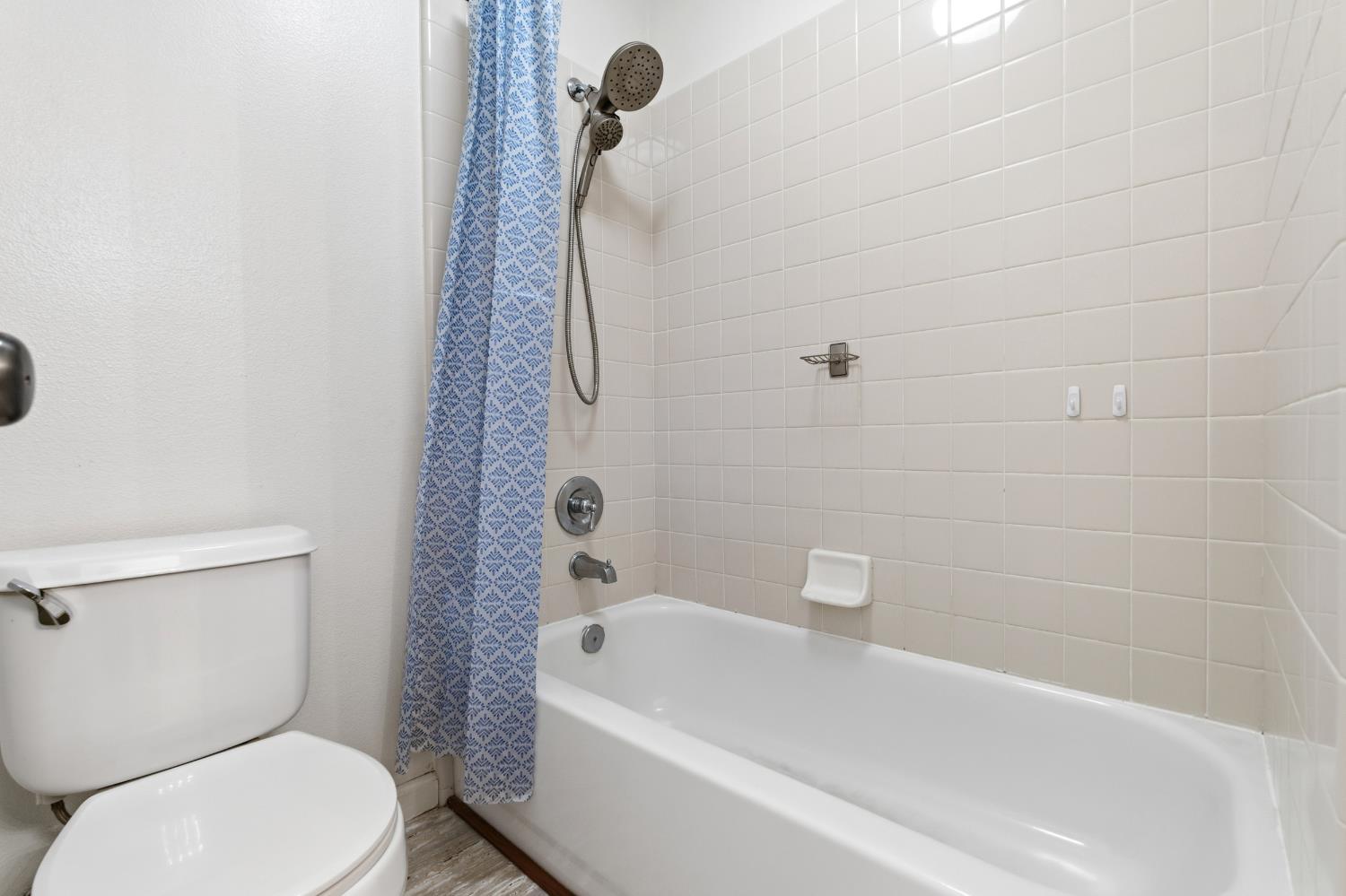 384 Millbrook Street Hanford, CA 93230 - Photo 37 of 59 a white toilet sitting next to a bath tub