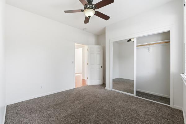 384 Millbrook Street Hanford, CA 93230 - Photo 38 of 59 a view of empty room with a ceiling fan