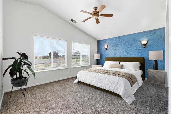 384 Millbrook Street Hanford, CA 93230 - Photo 41 of 59 a bedroom with a bed and a chandelier