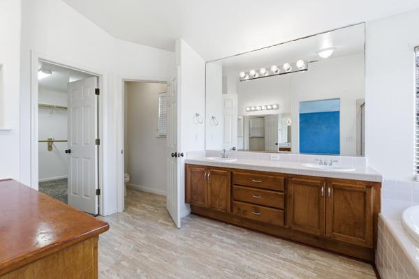 384 Millbrook Street Hanford, CA 93230 - Photo 44 of 59 a spacious bathroom with a granite countertop sink mirror and a