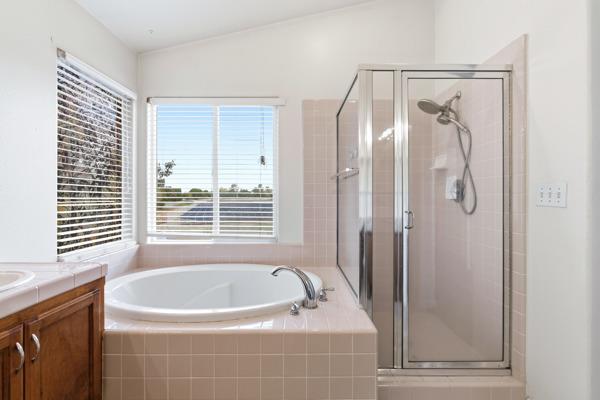 384 Millbrook Street Hanford, CA 93230 - Photo 46 of 59 a bathroom with a bathtub and a shower