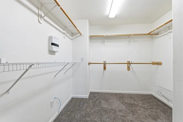 a view of a pathway with a wrought fence