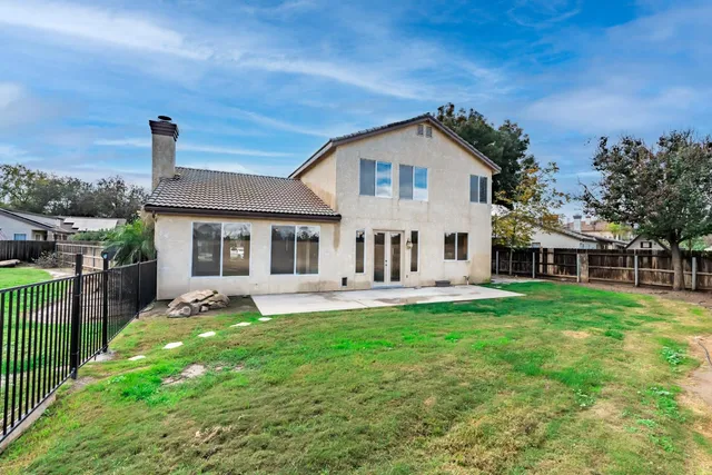 an aerial view of a house with outdoor space and street view