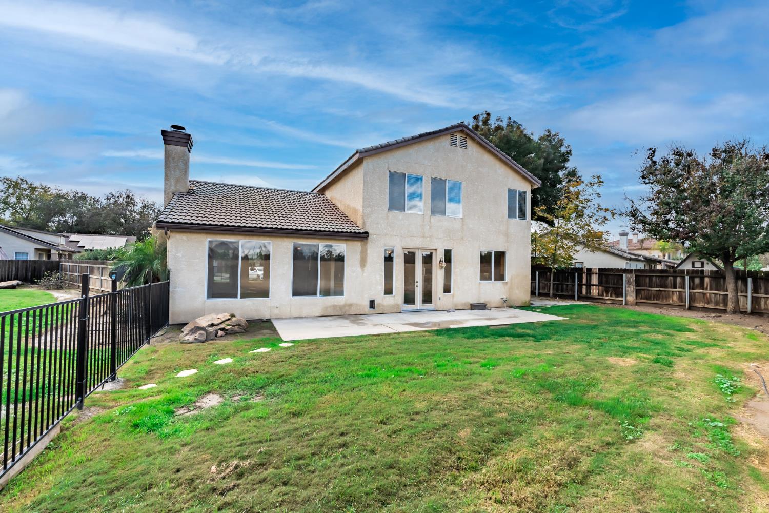 384 Millbrook Street Hanford, CA 93230 - Photo 49 of 59 a view of a house with a yard and deck