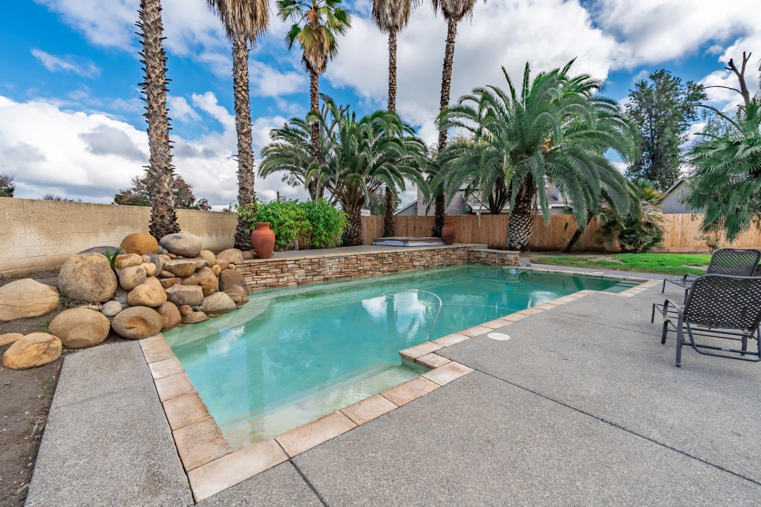 384 Millbrook Street Hanford, CA 93230 - Photo 51 of 59 a view of a garden with a slide and a lake view