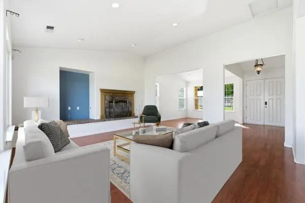 a living room with furniture and a wooden floor